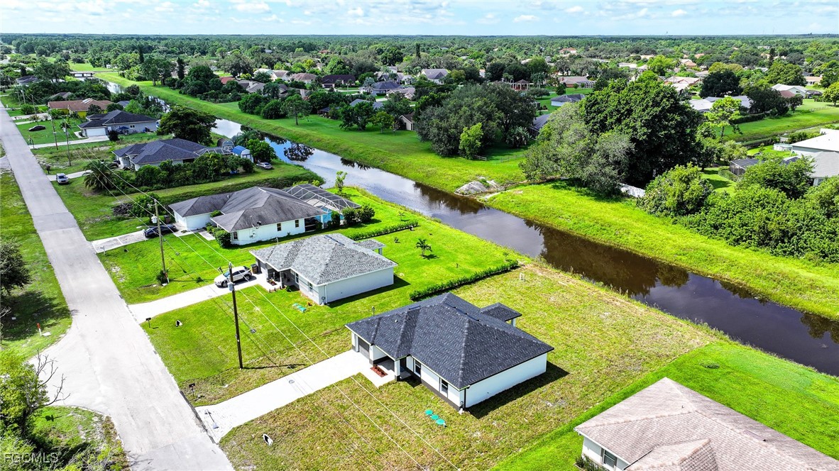 1018 Genoa Avenue South Lehigh Acres, FL 33974 - Photo 19 of 22 an aerial view of a house having garden
