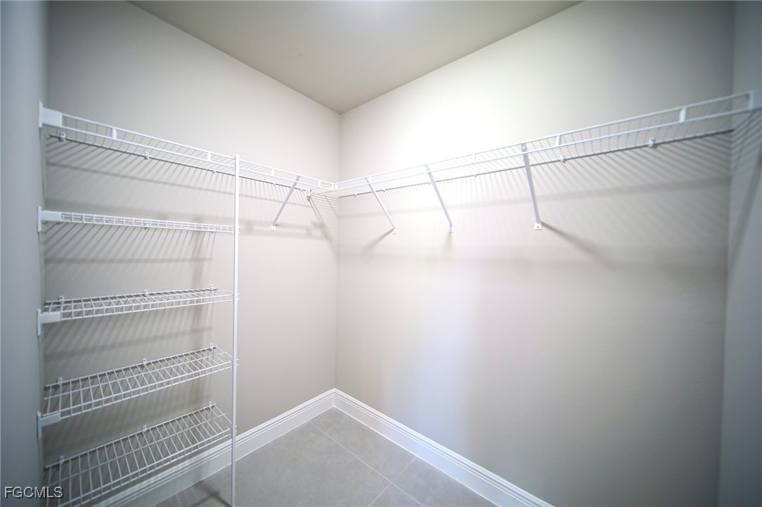 1018 Genoa Avenue South Lehigh Acres, FL 33974 - Photo 8 of 22 a view of a room with racks on the wall