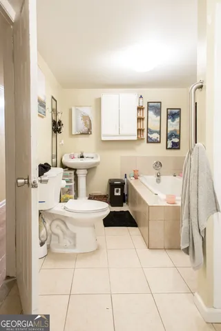 a bathroom with a sink a toilet and bathtub