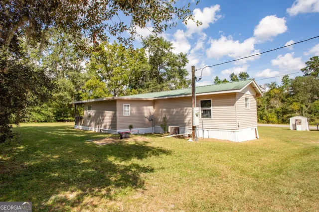 a backyard of a house with table and chairs