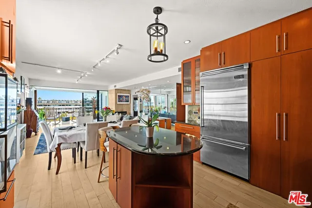 a kitchen with stainless steel appliances granite countertop a refrigerator a oven and a refrigerator