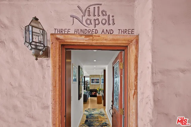 a view of a hallway with wooden shelves