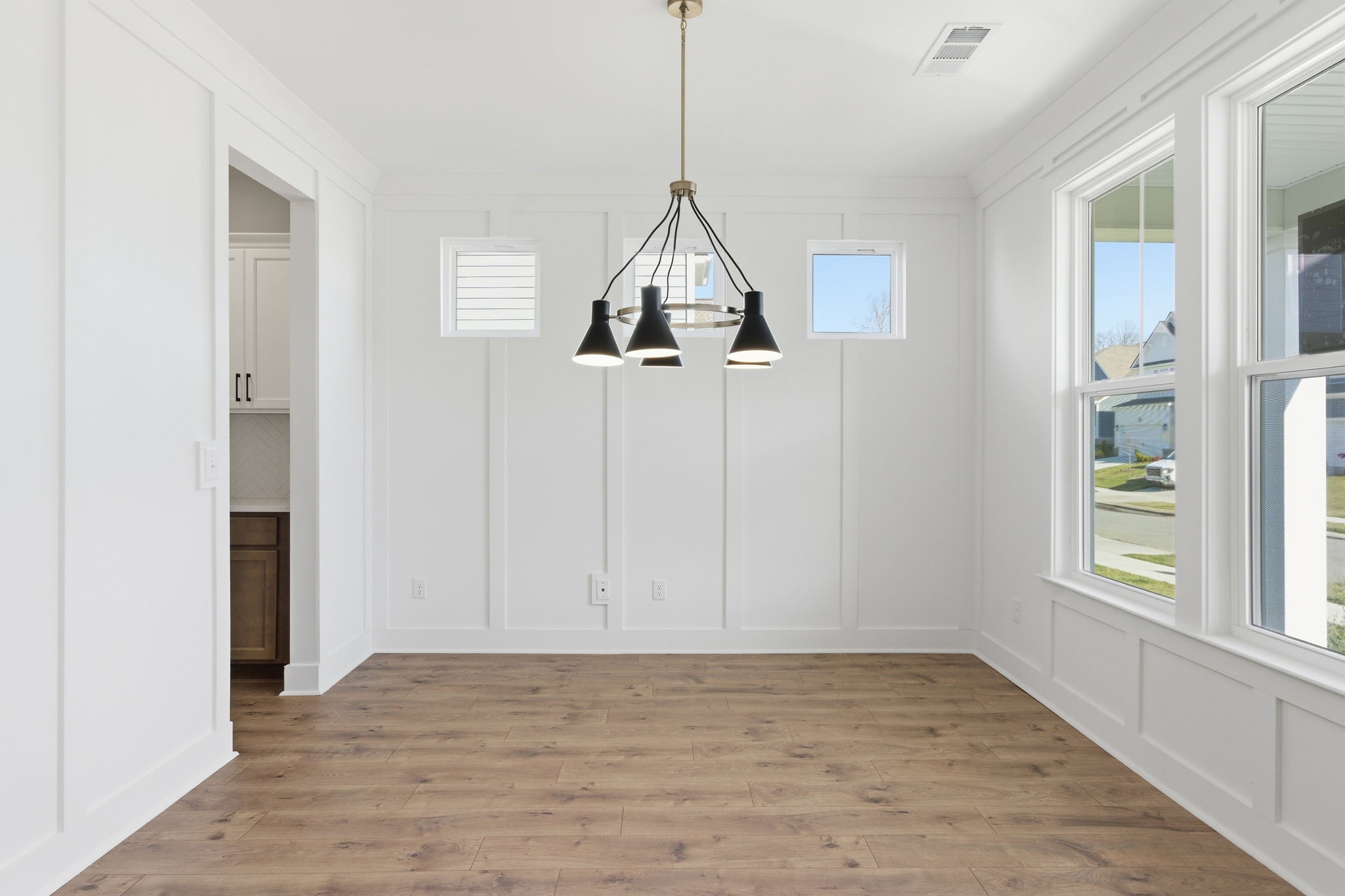 814 Sugarbush Lane Spring Hill, TN 37174 - Photo 10 of 80 a view of a room with wooden floor ceiling fan and windows