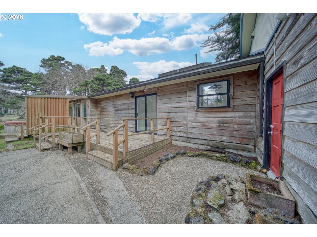 1260 Jackson Avenue Southwest Bandon, OR 97411 - Photo 11 of 48 a backyard of a house with barbeque oven and outdoor seating