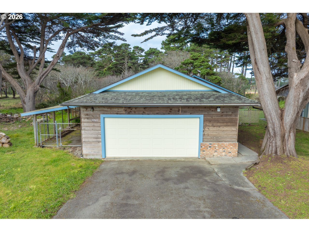 1260 Jackson Avenue Southwest Bandon, OR 97411 - Photo 2 of 48 a house with trees in the background