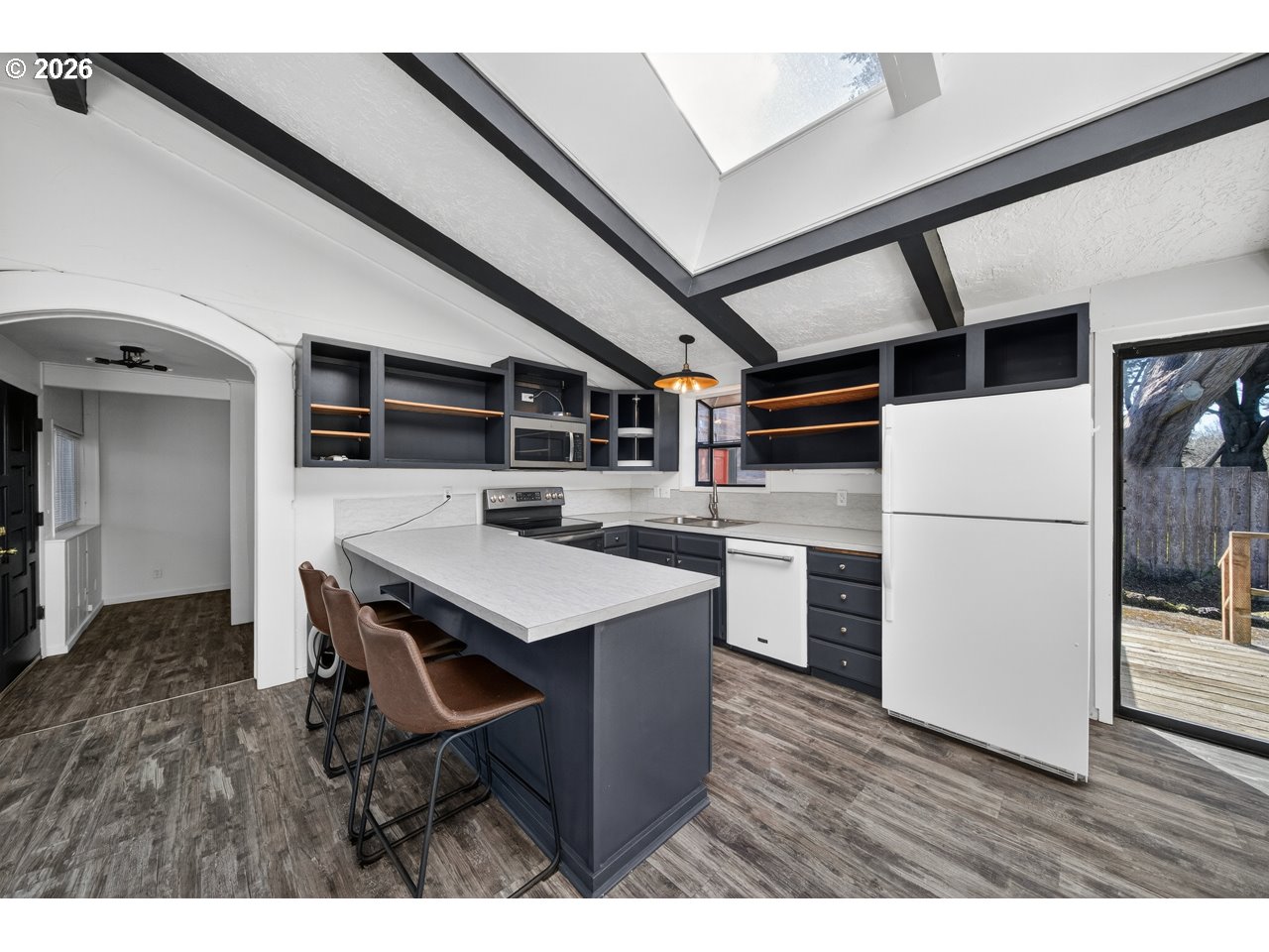 1260 Jackson Avenue Southwest Bandon, OR 97411 - Photo 23 of 48 a kitchen with a refrigerator and a stove top oven