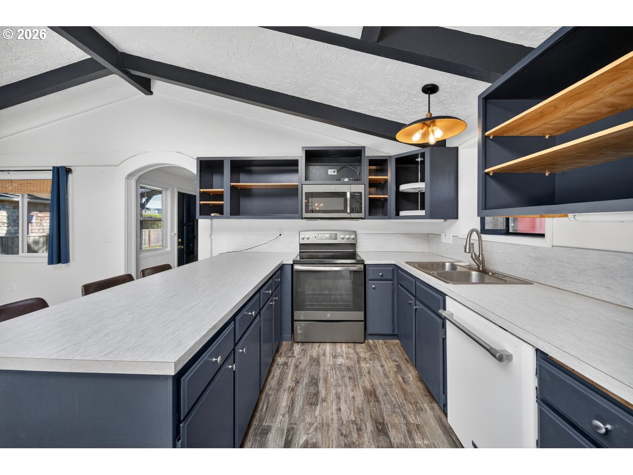 1260 Jackson Avenue Southwest Bandon, OR 97411 - Photo 24 of 48 a kitchen with stainless steel appliances granite countertop a sink and cabinets