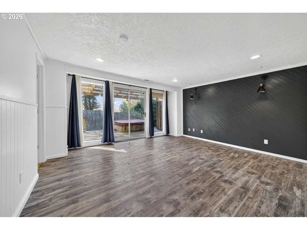 1260 Jackson Avenue Southwest Bandon, OR 97411 - Photo 25 of 48 a view of an empty room with wooden floor and a window