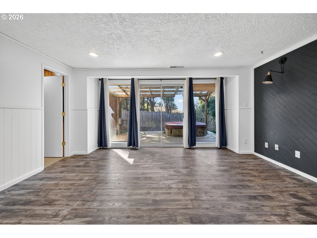 1260 Jackson Avenue Southwest Bandon, OR 97411 - Photo 26 of 48 a view of an empty room with wooden floor and a window
