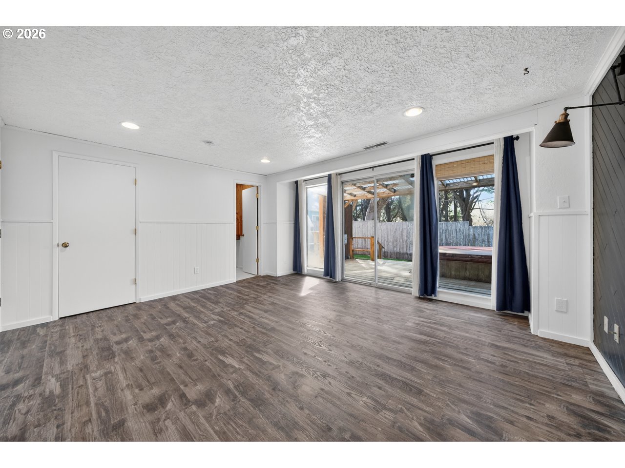 1260 Jackson Avenue Southwest Bandon, OR 97411 - Photo 27 of 48 a view of an empty room with wooden floor and a window