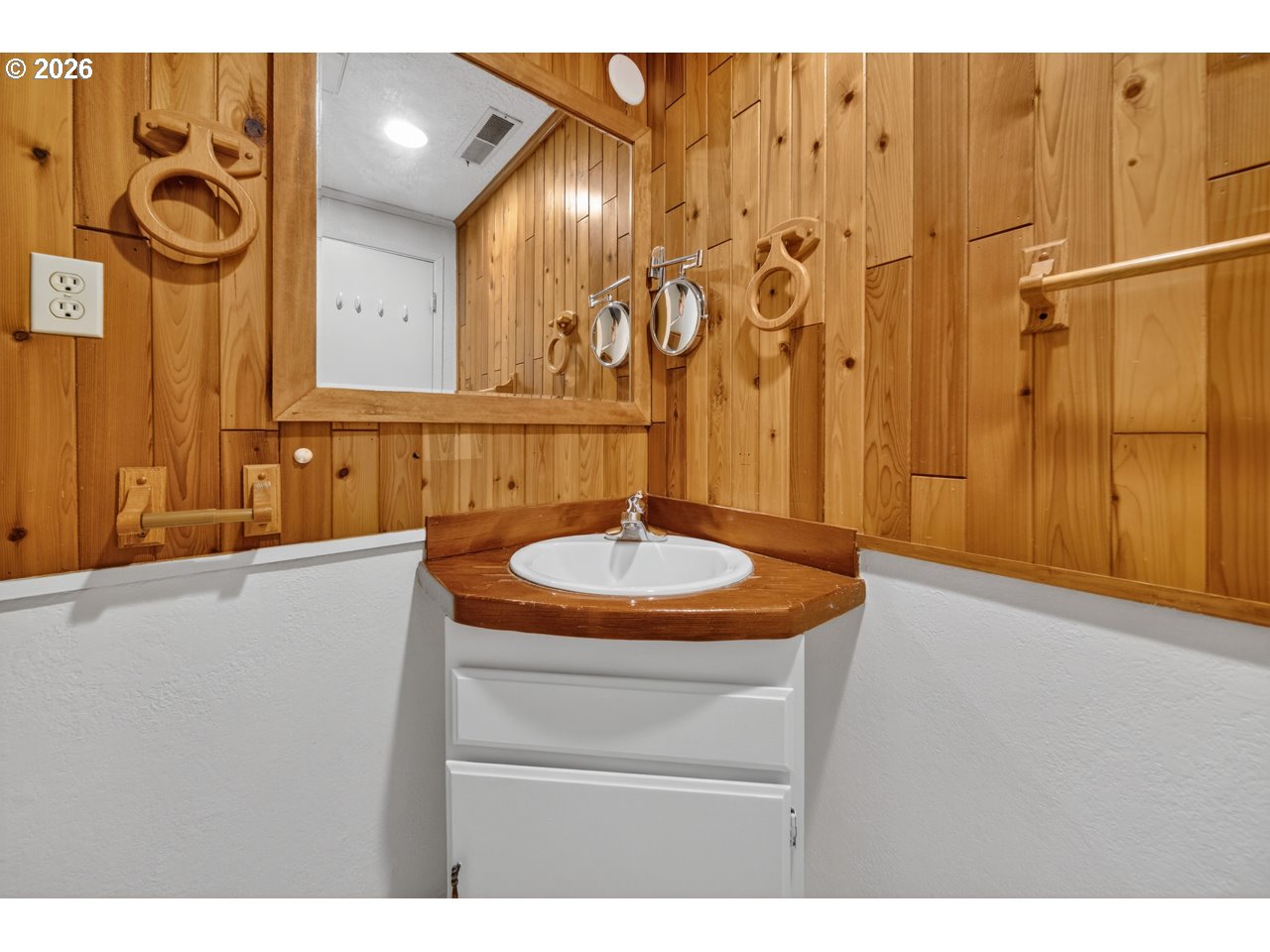 1260 Jackson Avenue Southwest Bandon, OR 97411 - Photo 28 of 48 a bathroom with a sink and a mirror