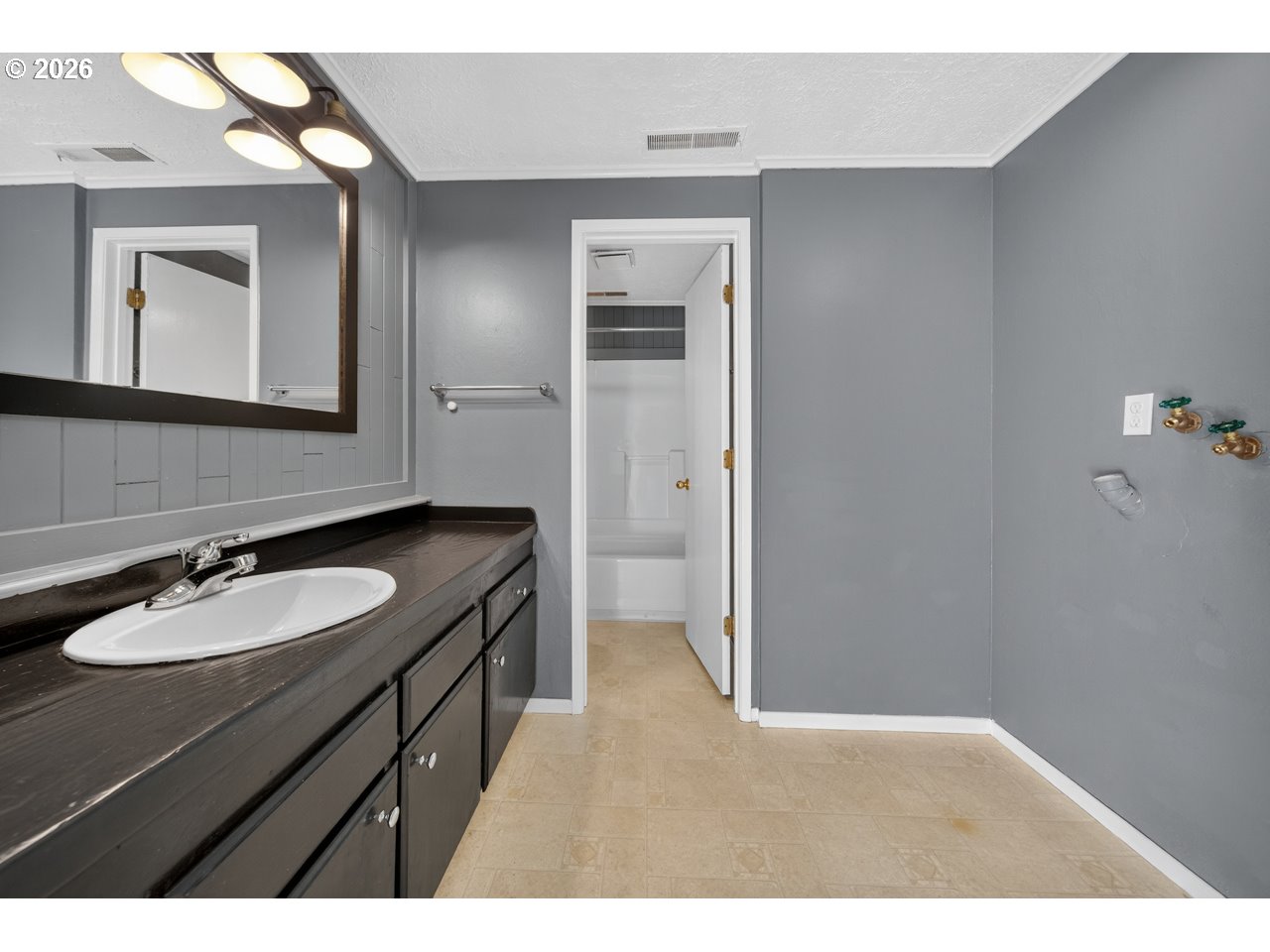 1260 Jackson Avenue Southwest Bandon, OR 97411 - Photo 30 of 48 a bathroom with a sink and a mirror