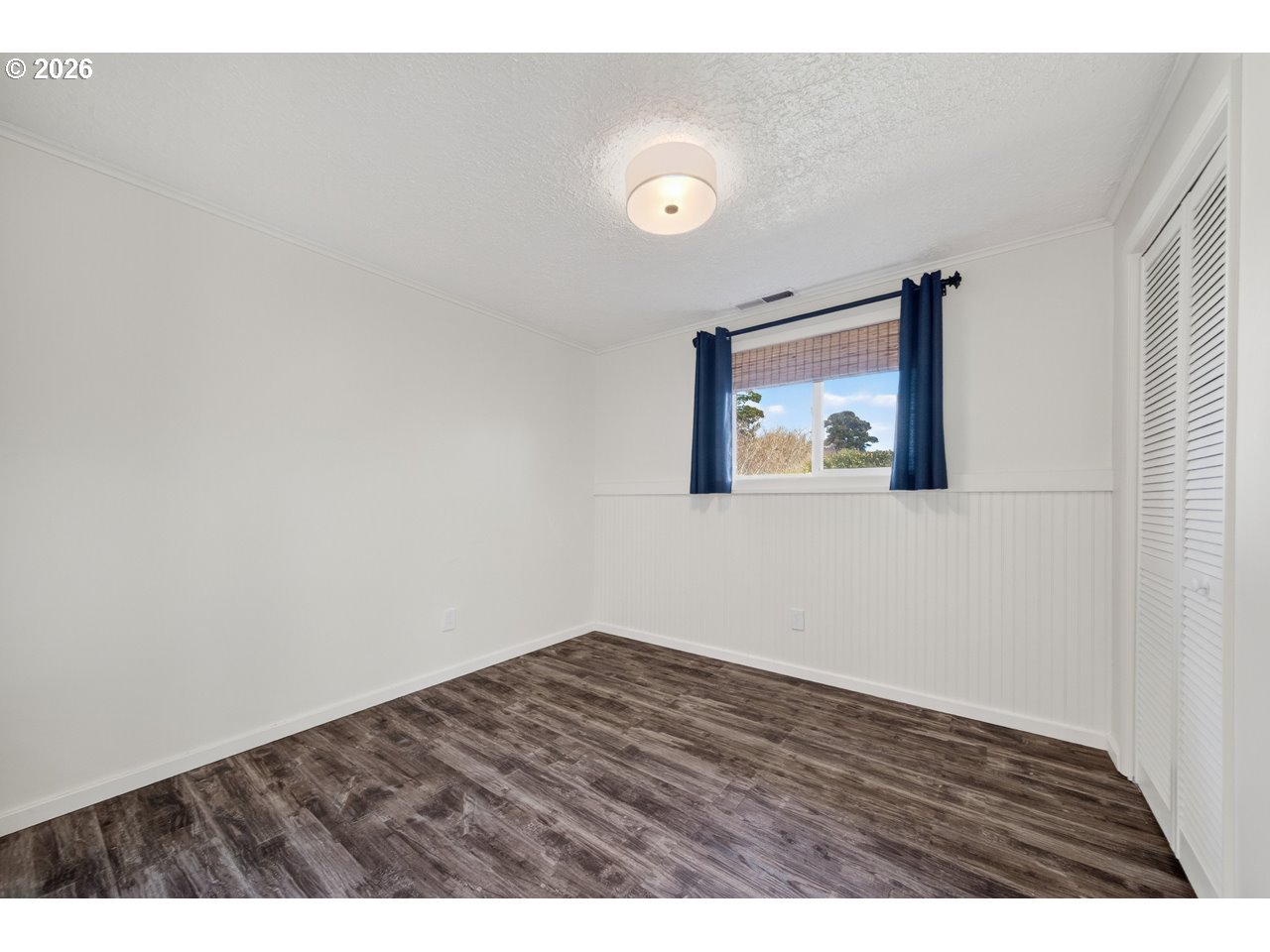 1260 Jackson Avenue Southwest Bandon, OR 97411 - Photo 35 of 48 a view of an empty room with wooden floor and a window
