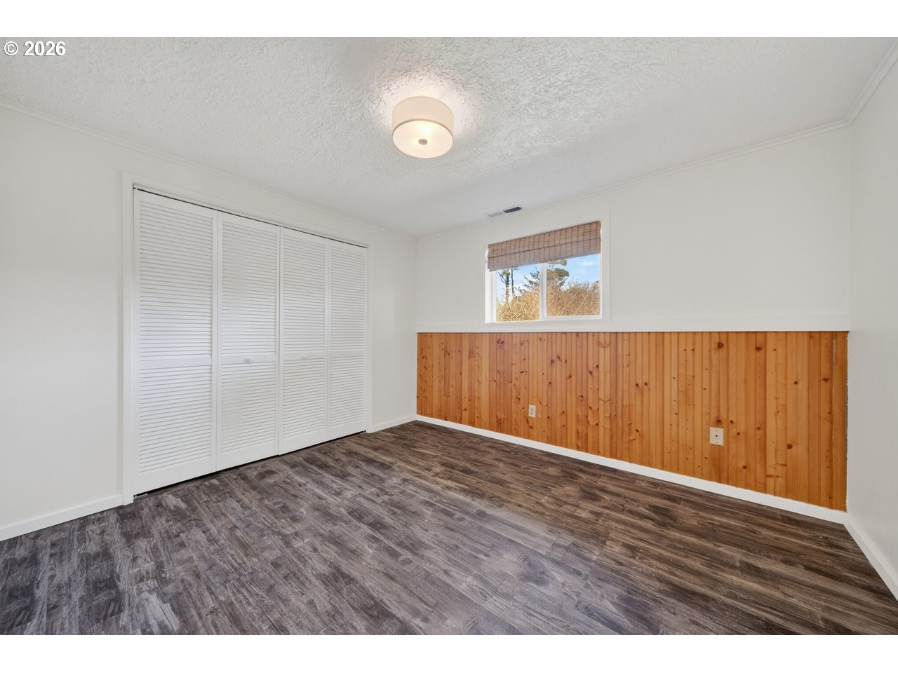 1260 Jackson Avenue Southwest Bandon, OR 97411 - Photo 37 of 48 a view of an empty room with wooden floor