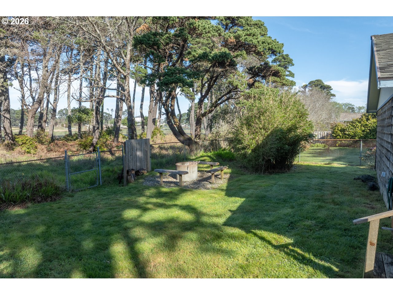 1260 Jackson Avenue Southwest Bandon, OR 97411 - Photo 46 of 48 a backyard of a house with table and chairs