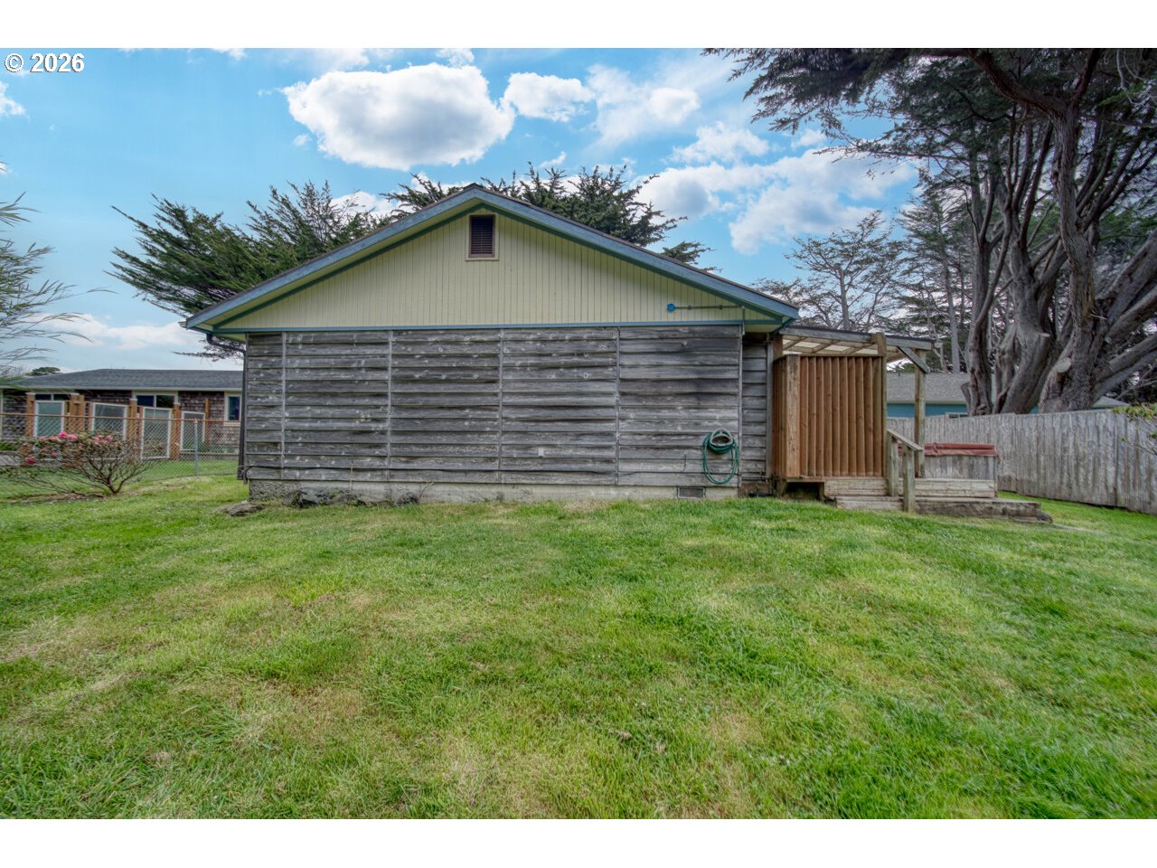 1260 Jackson Avenue Southwest Bandon, OR 97411 - Photo 9 of 48 a backyard of a house with plants and barbeque oven