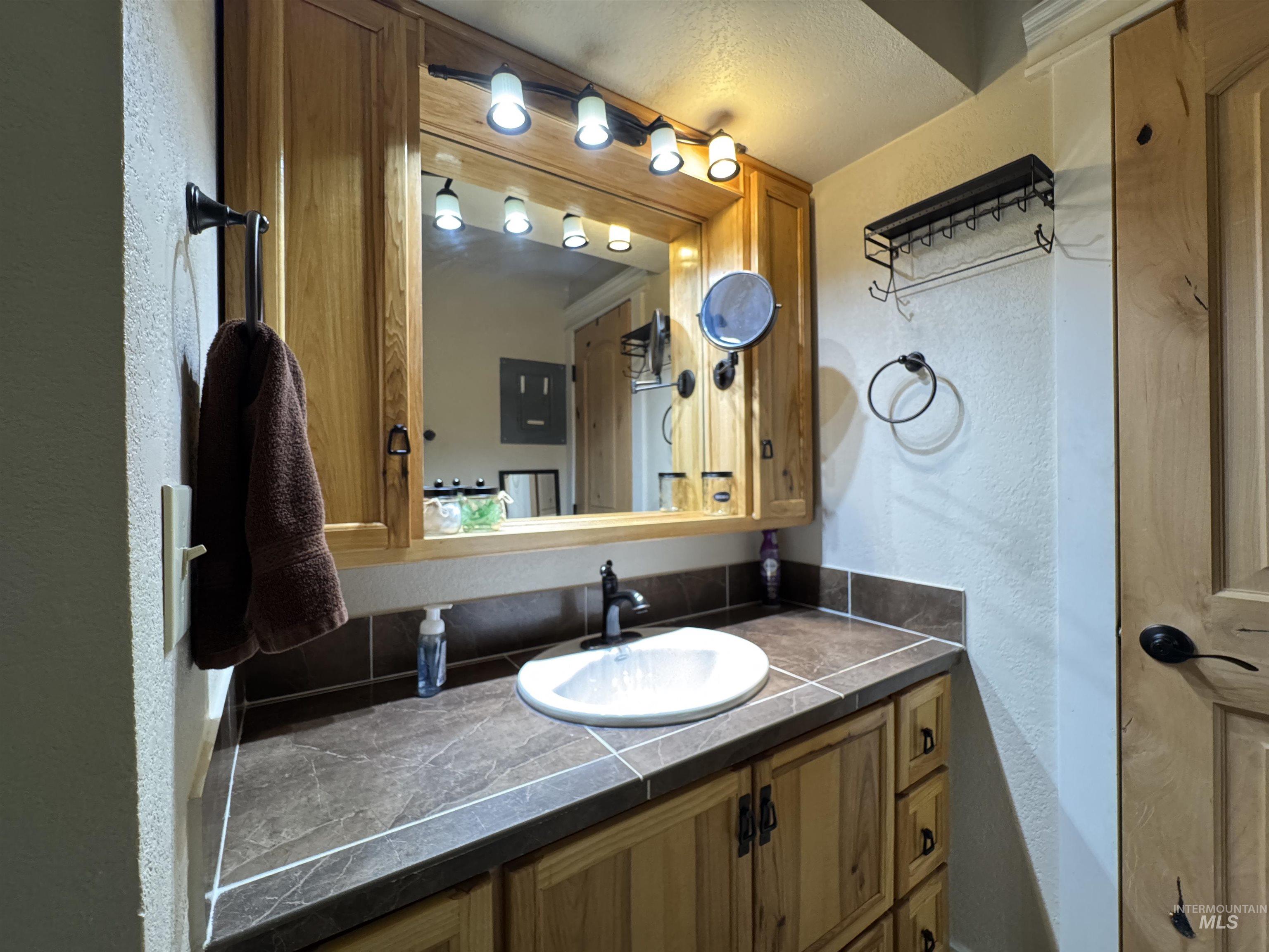304 McBride Street, Unit 107 107 McCall, ID 83638 - Photo 19 of 28 Bathroom featuring a textured wall and vanity