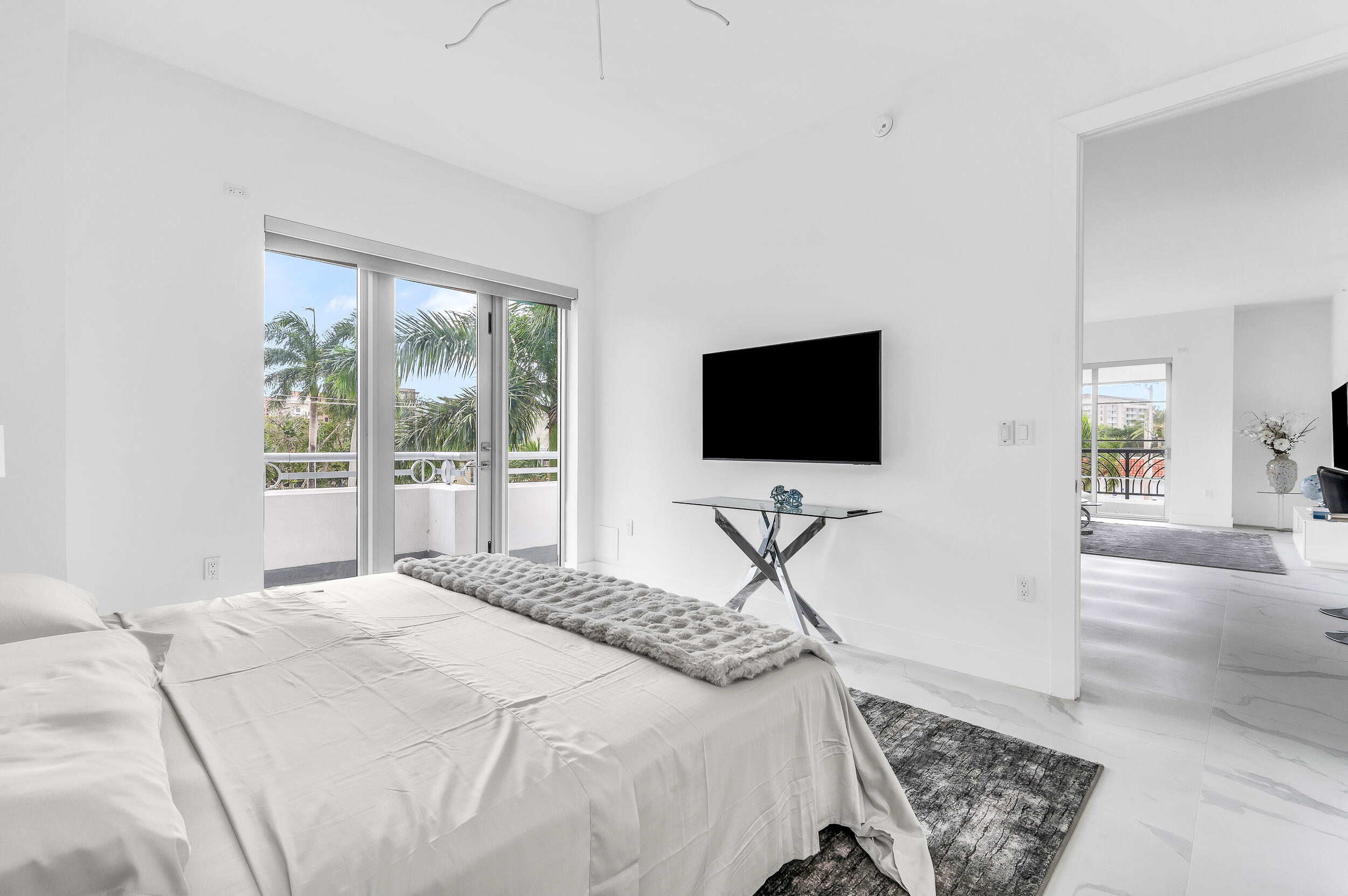 155 East Boca Raton Road, Unit 303 Boca Raton, FL 33432 - Photo 13 of 38 a bedroom with a bed and a flat screen tv