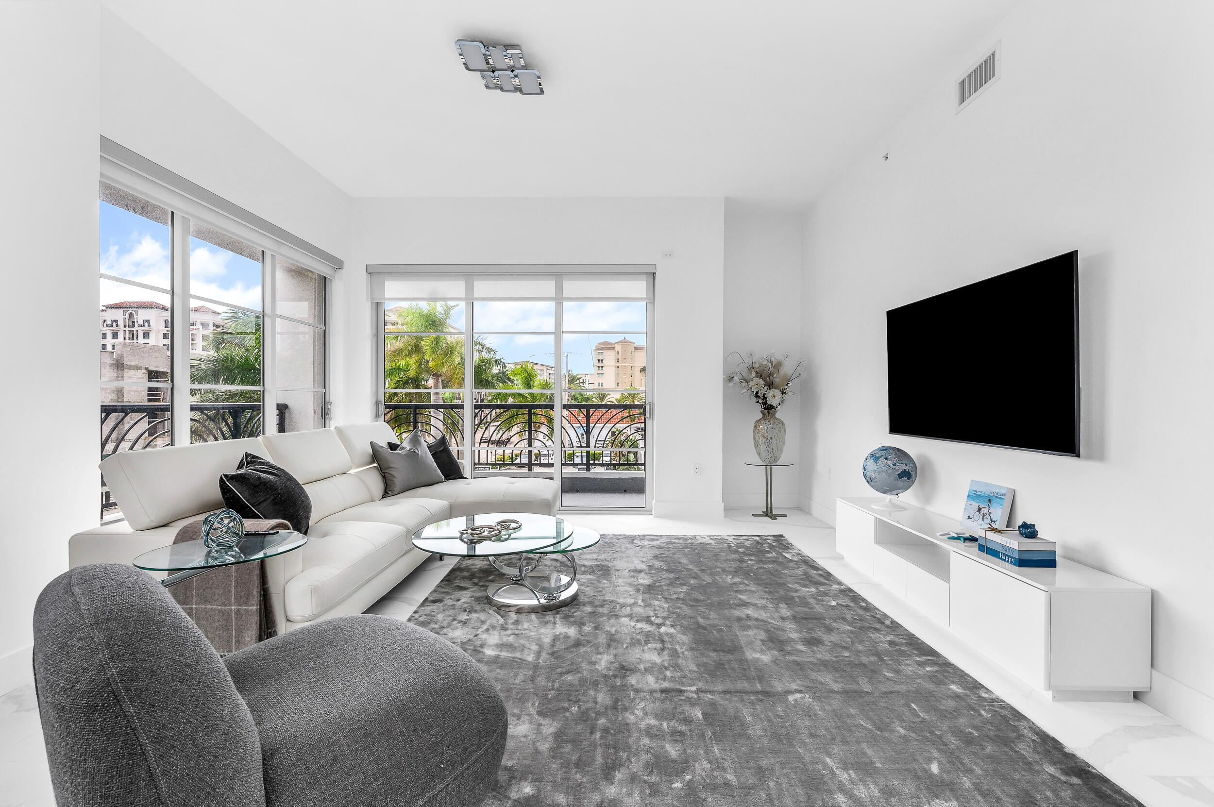 155 East Boca Raton Road, Unit 303 Boca Raton, FL 33432 - Photo 6 of 38 a living room with furniture and a flat screen tv
