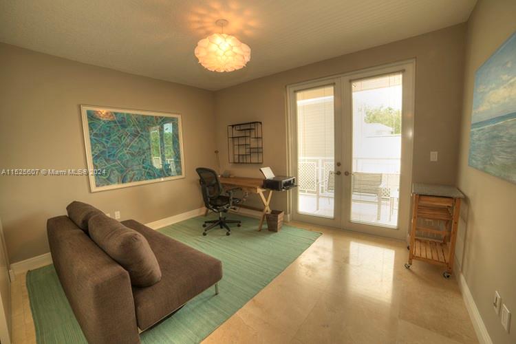 3540 Main Highway, Unit 305 Miami, FL 33133 - Photo 4 of 14 a living room with furniture and a large window