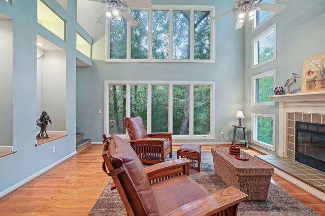 a living room with fireplace furniture and a chandelier