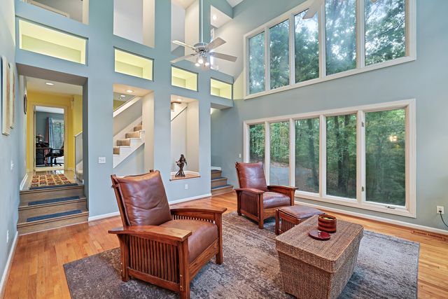 a living room with furniture and floor to ceiling windows