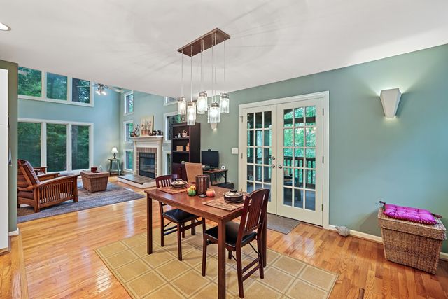 a kitchen with stainless steel appliances kitchen island granite countertop a dining table and chairs in it
