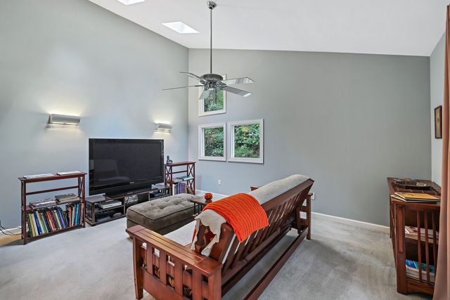 a bedroom with furniture and a large window