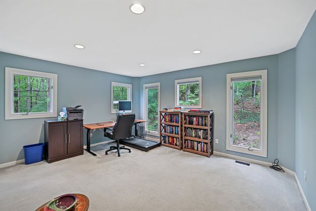 a view of a workspace with furniture and a bookshelf