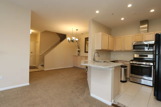 a kitchen with stainless steel appliances granite countertop a stove and a sink