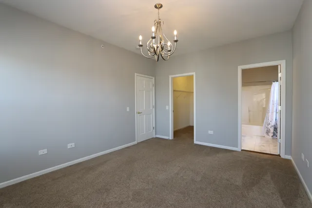 a view of a chandelier in big room and a chandelier