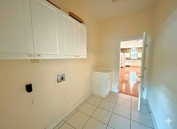 a view of a storage & utility room with a sink