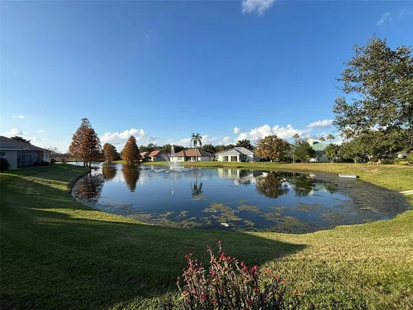 a view of a lake with houses in the back
