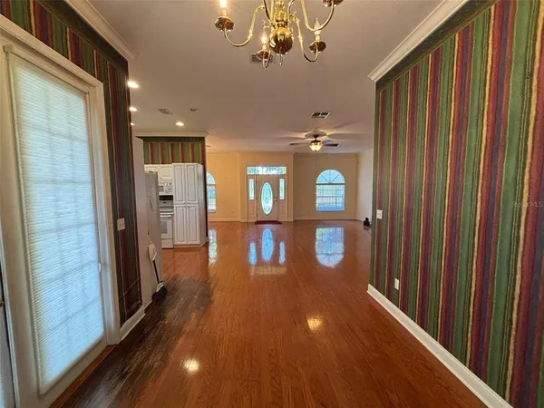 a view of a hallway with wooden floor