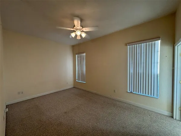 a view of a livingroom with a chandelier fan