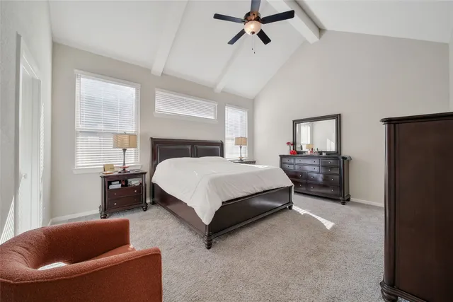 a bedroom with a bed couch and window