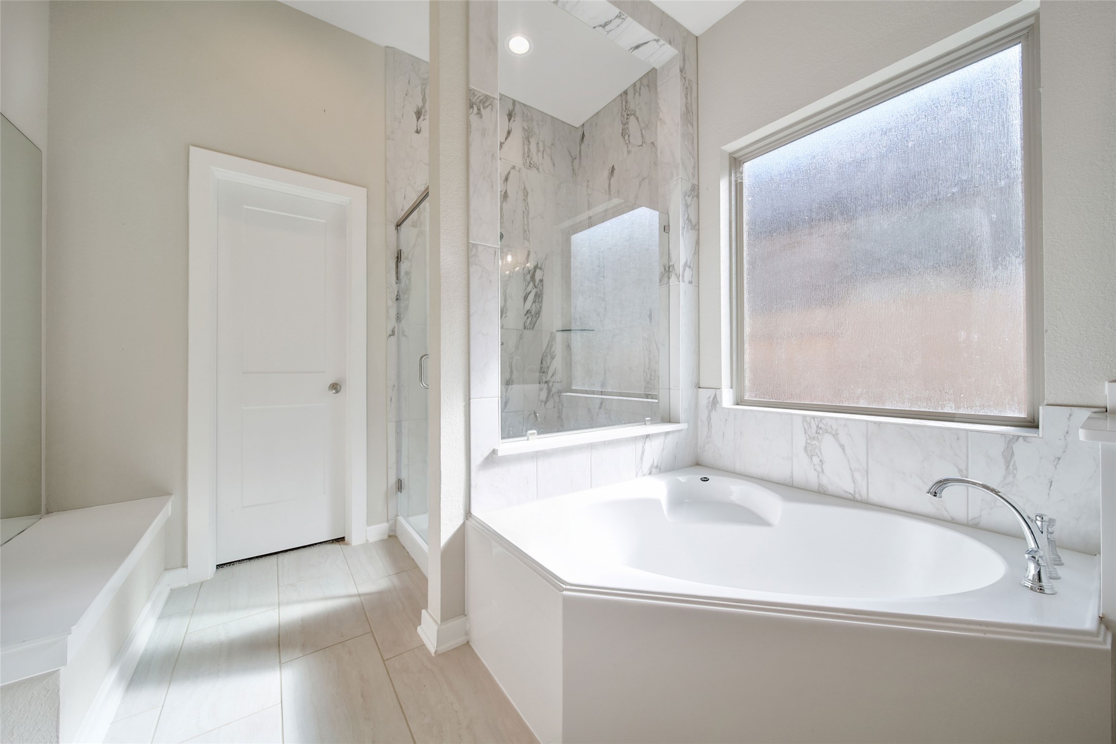 128 Yellow Perch Way Willis, TX 77318 - Photo 18 of 32 a bathroom with a sink a mirror and a bathtub