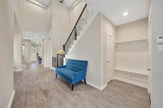 a living room with wooden floor and stairs