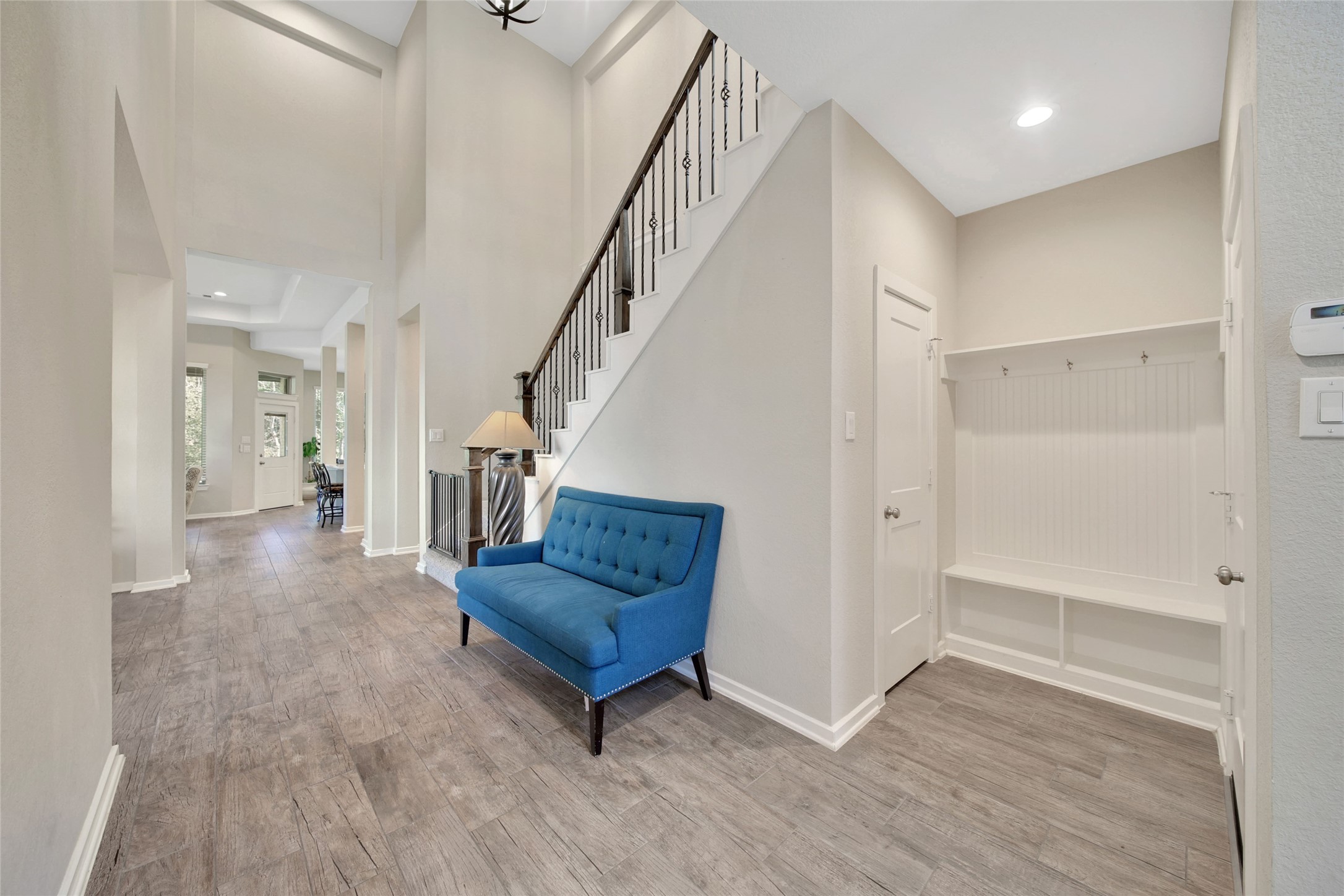 128 Yellow Perch Way Willis, TX 77318 - Photo 19 of 32 a living room with wooden floor and stairs