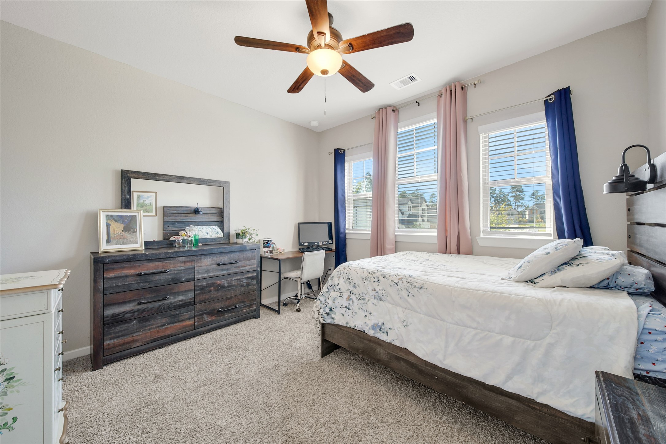 128 Yellow Perch Way Willis, TX 77318 - Photo 23 of 32 a bedroom with a bed and a dresser