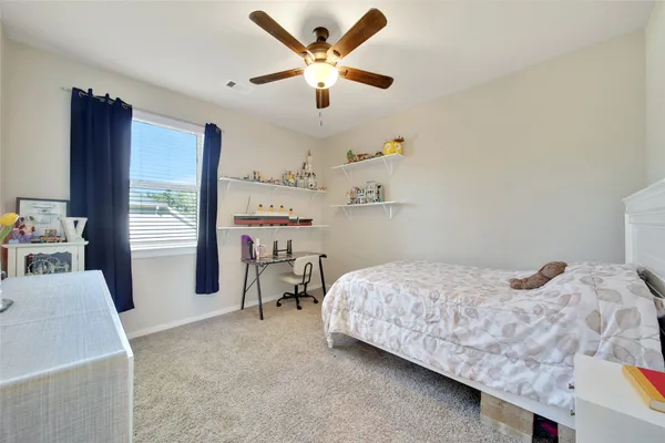 a bedroom with a bed furniture and a large window