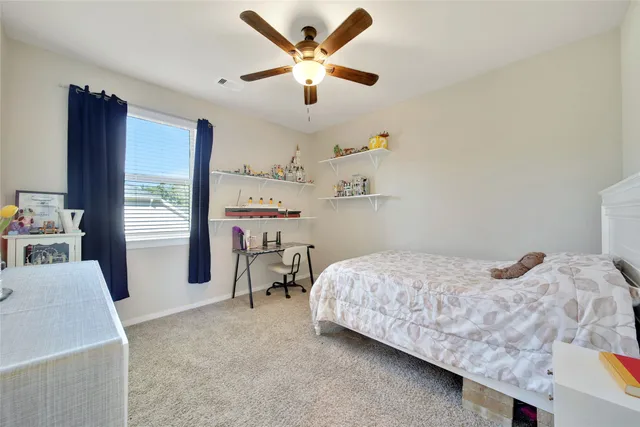 a bedroom with a bed furniture and a large window
