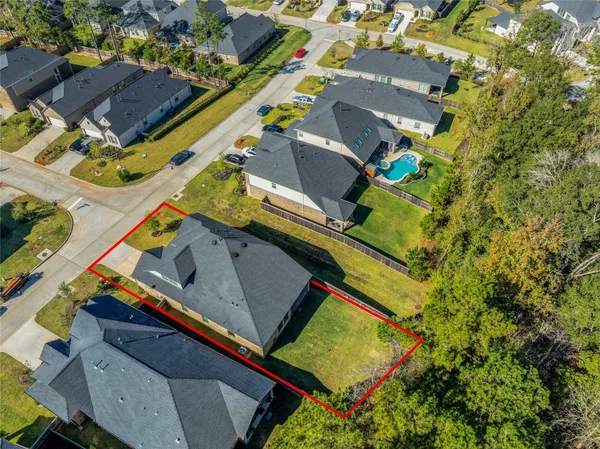 an aerial view of a house with a yard