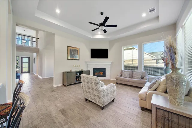 a living room with furniture a fireplace and a flat screen tv
