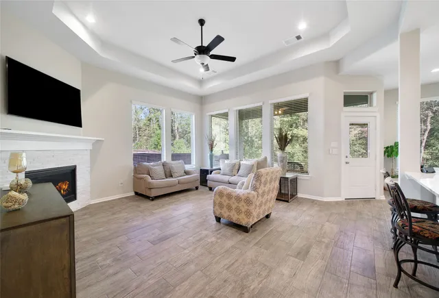 a living room with furniture fireplace and flat screen tv
