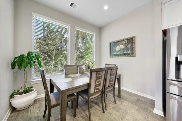 a dining room with furniture and window