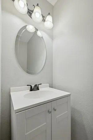 a bathroom with a sink a mirror and vanity