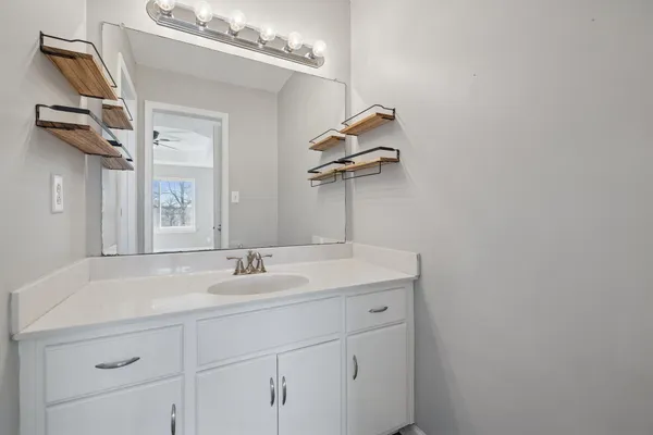 a bathroom with a sink and a mirror