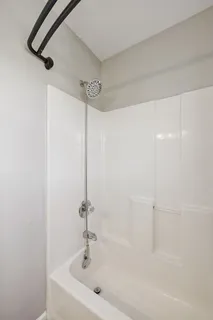 an empty room with closet and a ceiling fan