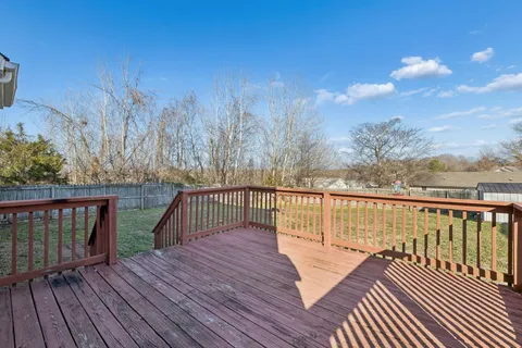 a view of a backyard with barn and wooden fence